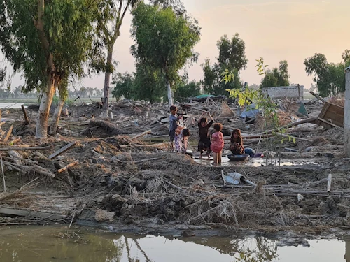 Börn að leik í rústunum eftir flóðin í Pakistan.