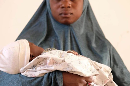 Tvö börn. Fatou er þrettán ára stúlka frá Gao í Malí. Hún heldur hér á tveggja mánaða gömlu barni sínu. Hún var heimilislaus stóran hluta meðgöngunnar. UNICEF vann með henni að sameinast aftur fjölskyldu sinni.© UNICEF